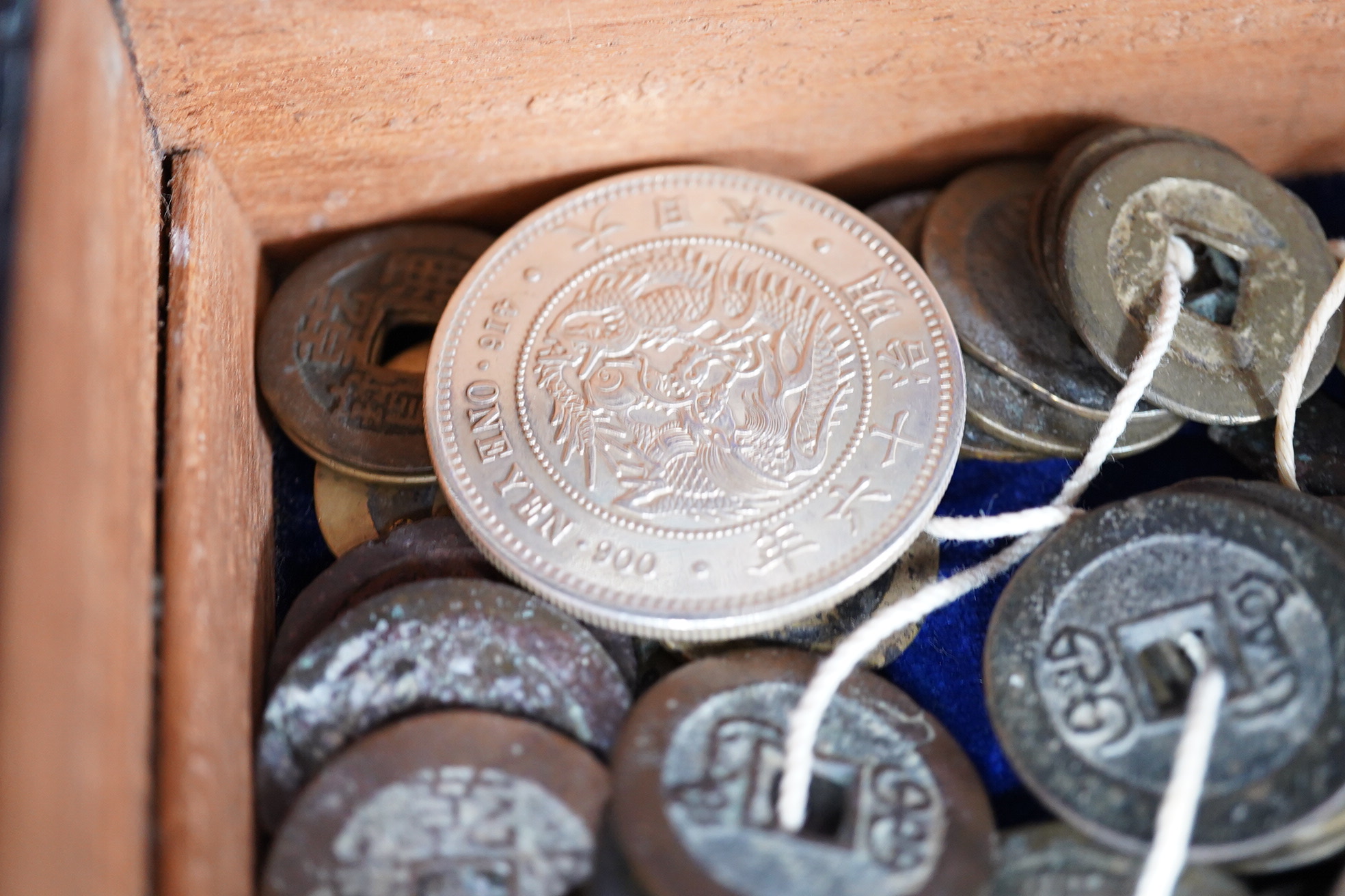 Chinese and Japanese coins, 16th to 20th century, including Chinese cast coins, Ming to Qing dynasty, Japanese Kan’ei Tsuho, in a rosewood box